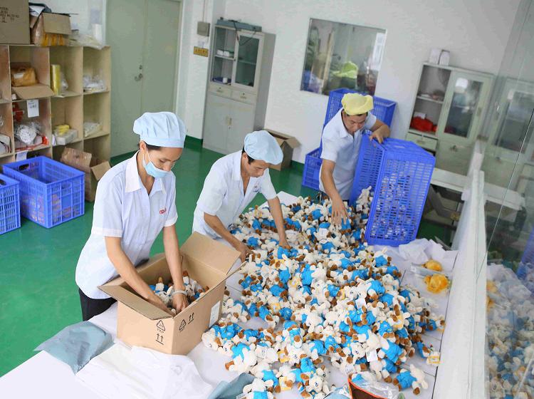 Plush products being prepared and packed in a workshop